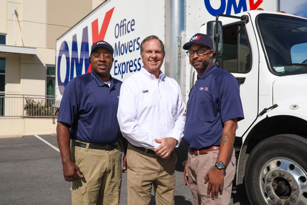 OMX moving team in front of truck