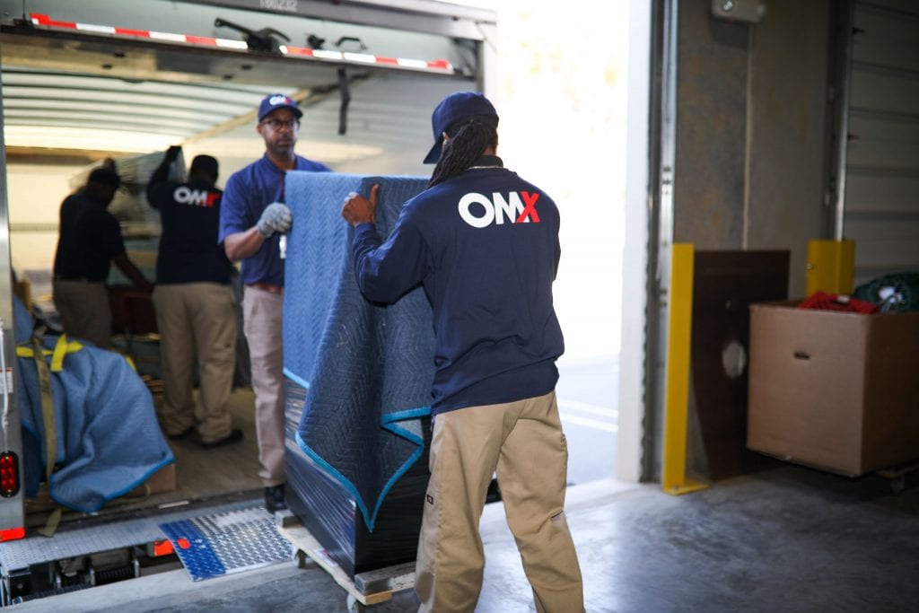 OMX movers off-loading truck