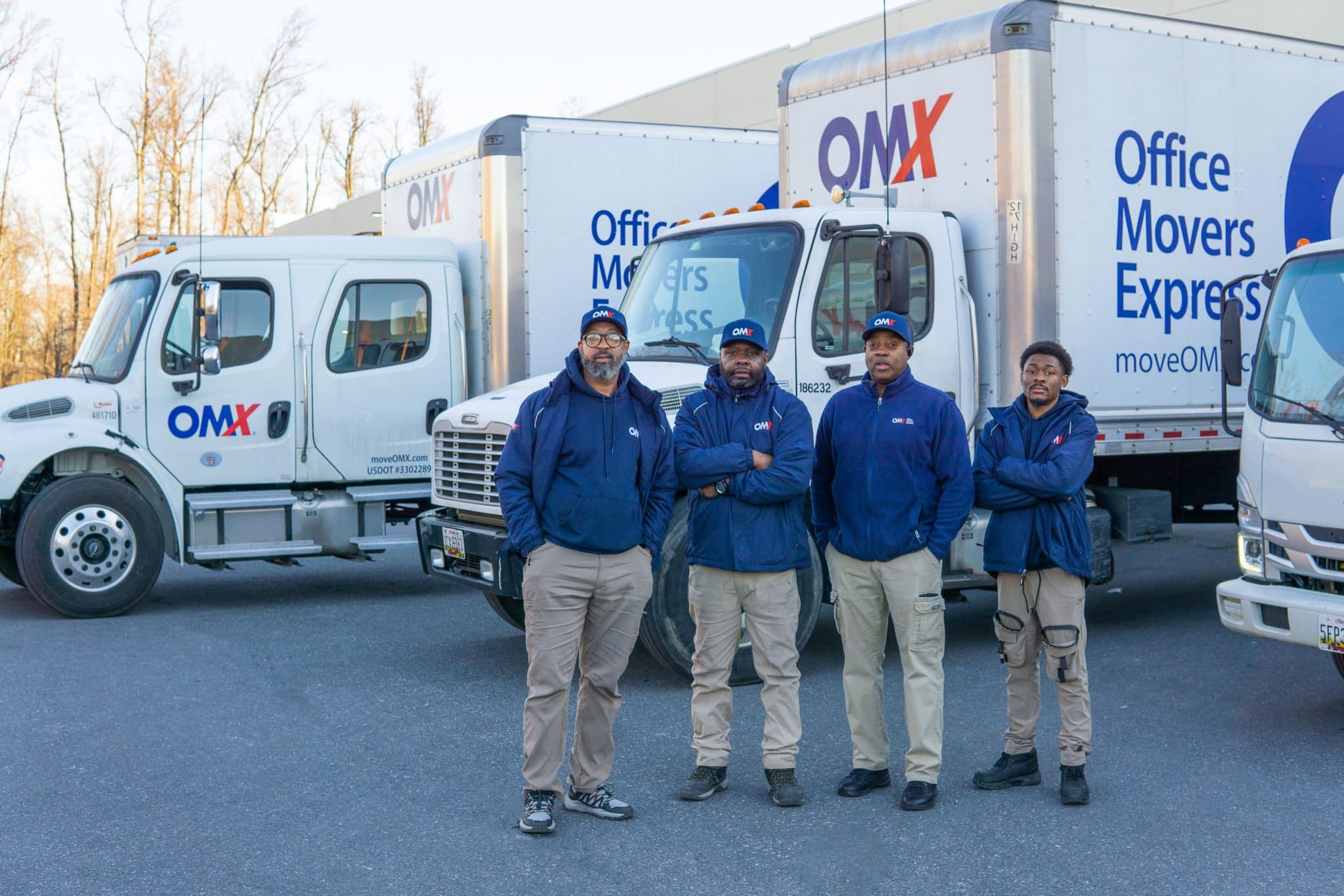 OMX movers standing in front of truck